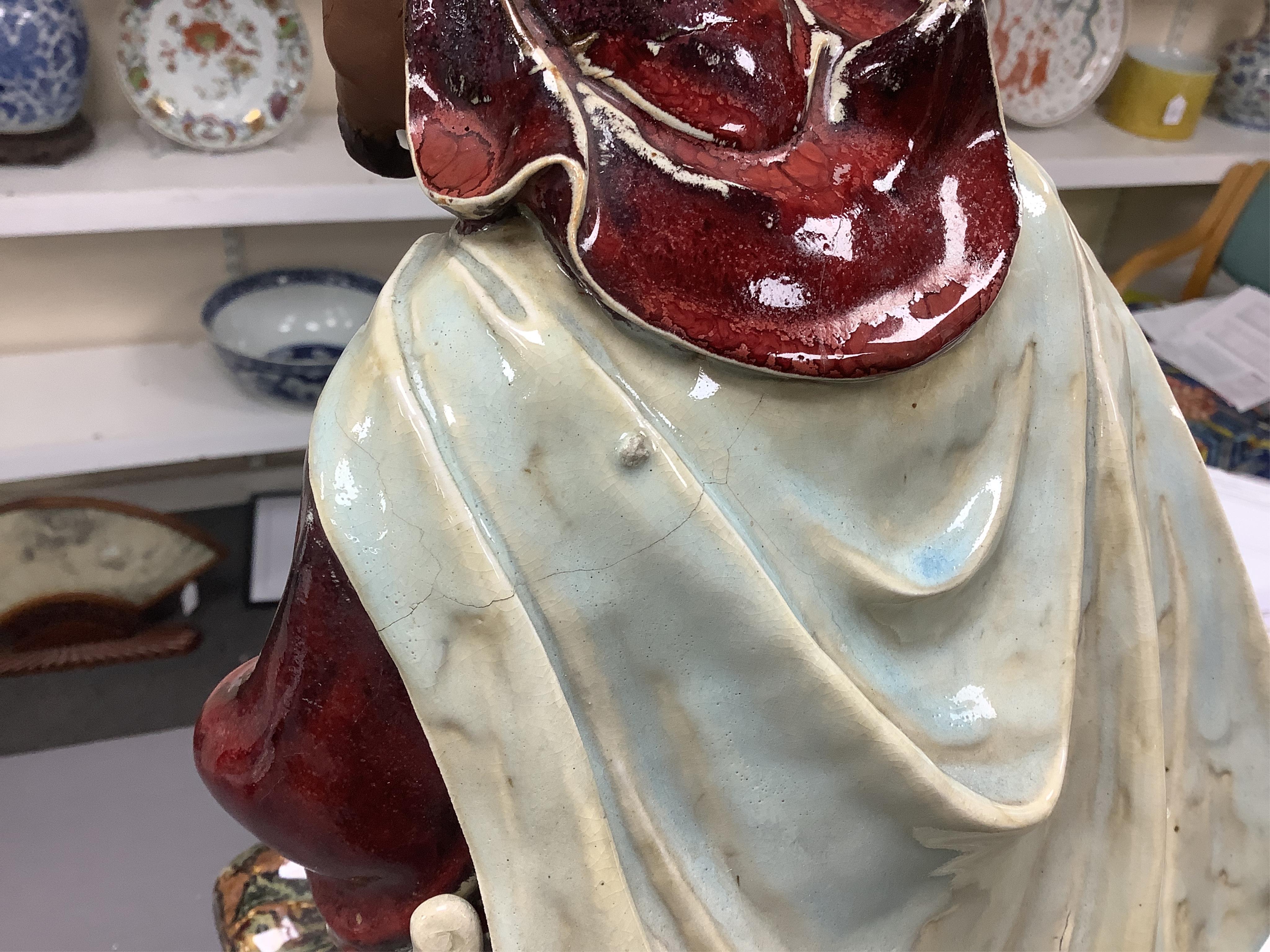 A large Chinese Shiwan stoneware figure of a warrior, 20th century